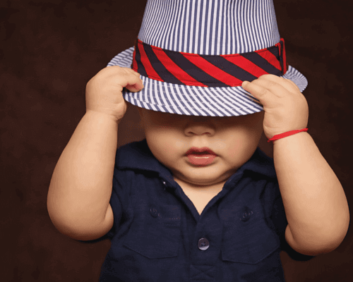Baby boy wearing a hat with red rim. Baby boy wearing a hat with red rim.