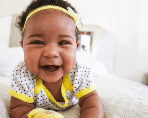 Baby girl lying on blanket and laughing. Baby girl lying on blanket and laughing.