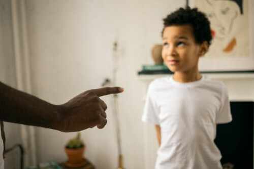 A boy is being scolded by his dad.