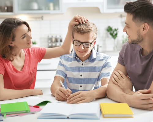 Boy doing homework with help.