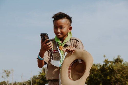 Boy looking at phone.