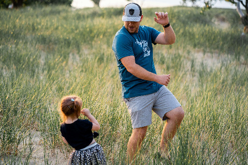 Dad dancing with girl.