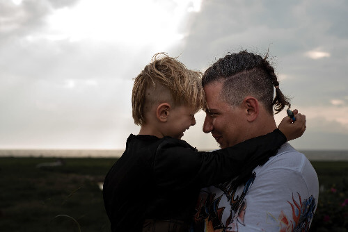 Dad and son touching forheads