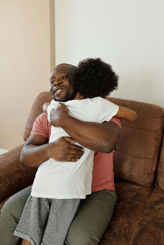 Dad and son hugging.