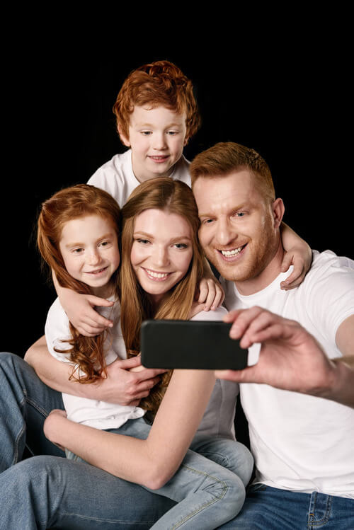 Close family looking towards camera