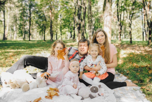 Family sitting outside on blanket