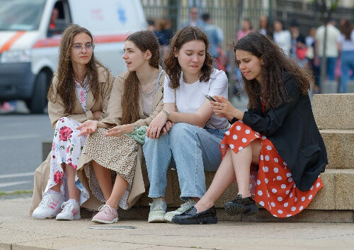 Teen friends on bench. 