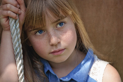 Girl leaning on her hand. 