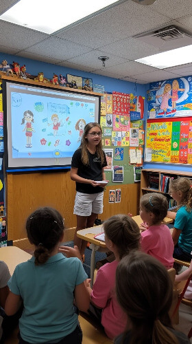 Girl speaking in front of smart board