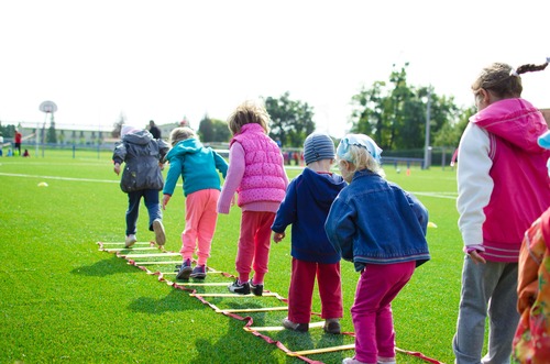 Kids playing hopscotch.