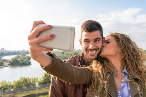 Man and woman happy together and taking a selfie.