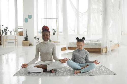 Mom meditating with her daughter. Mom meditating with her daughter.