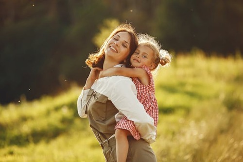 Mom carrying child on back