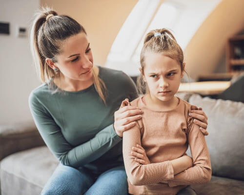 Mom comforting daughter who is angry.