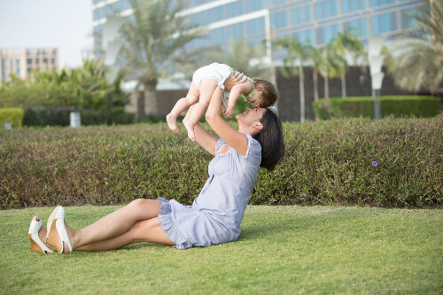Mom throwing baby in the air.