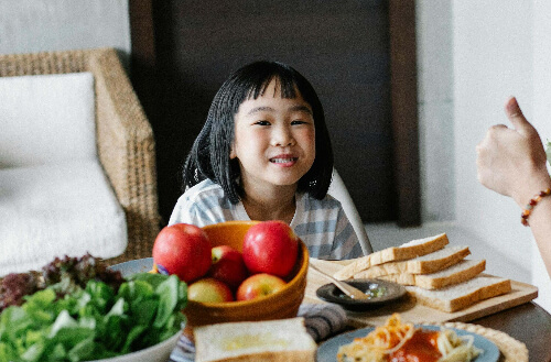 Smiling girl eating healthy.