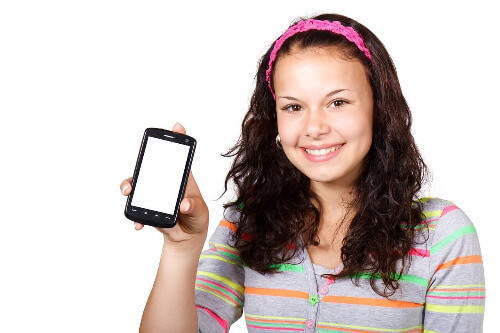 Teen holding phone up.