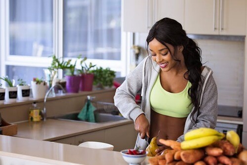 Woman cutting up some fruit.