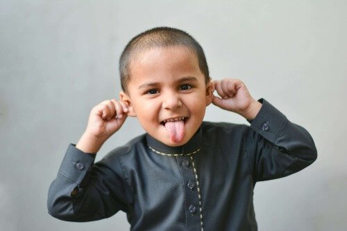 Boy pulling on ears