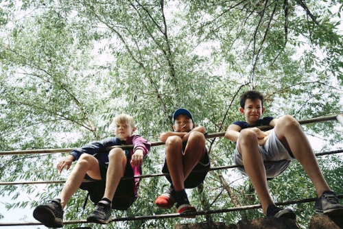Boys on a rope fence