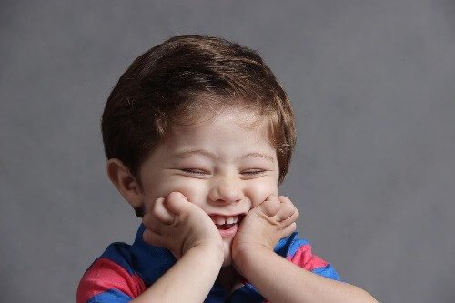 Boy with head in hands