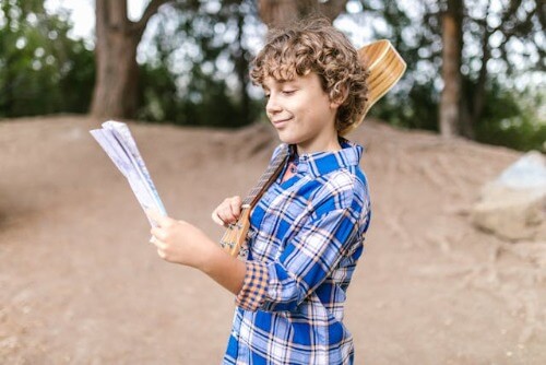 Boy holding treasure map.