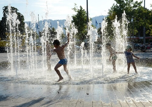 Children playing in sprinkler.