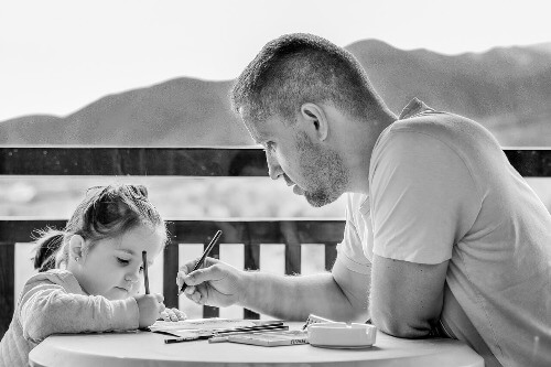 Dad and girl colouring. 