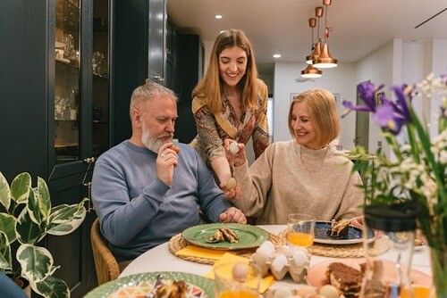 Daughter serving dinner to her parents. 