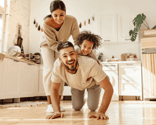 Family playing in kitchen.
