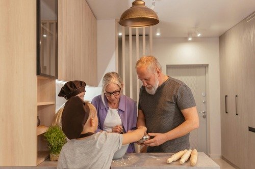 Grandparents in kitchen with grandkids, cooking