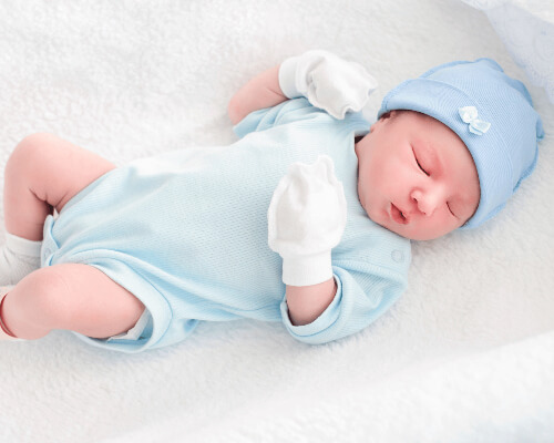 Infant baby boy in crib.