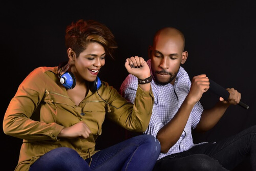 Man and woman dancing while sitting down.