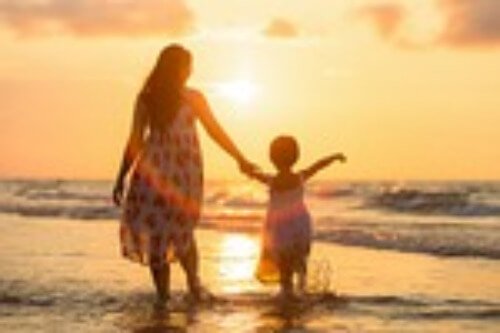 Mom and child waling in water. 