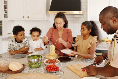 Mom, dad and kids preparing dinner.