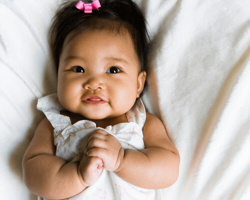 Newborn baby in crib.
