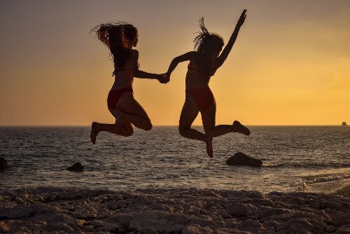 Teens jumping in the air.