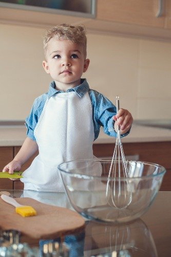 toddler mixing with whisk